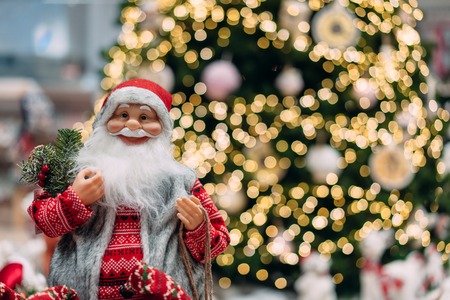 Happy Santa on background of bokeh christmas tree.の写真素材