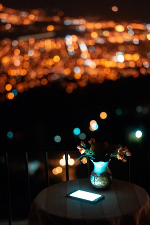 Image of wood table and blurred city bokeh background with colorful lights.の写真素材