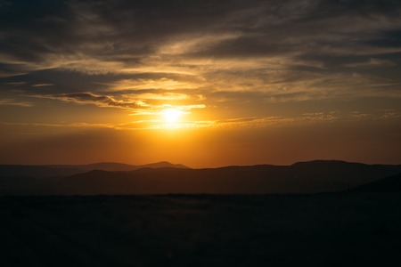 Orange majestic sunset in the mountains landscap.の写真素材