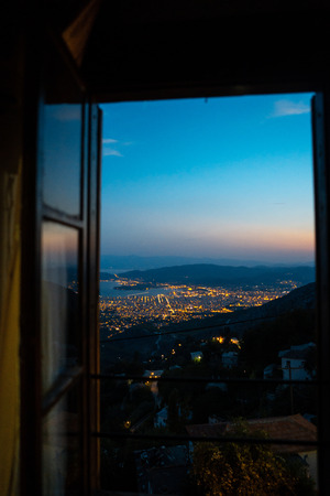 Glowing lights the Greek city from the window of the hotelの写真素材