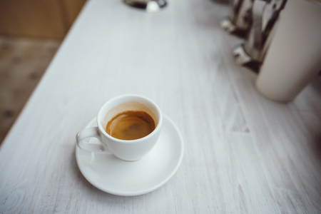 Cup of cappuccino on the white wooden table.の写真素材