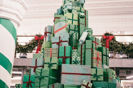 Christmas gift boxes laid out in the shape of a Christmas treeの写真素材