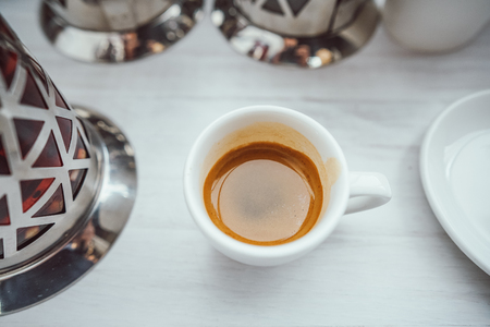 Cup of cappuccino on the white wooden table.の写真素材