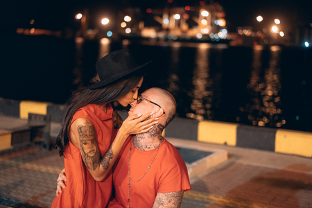 Young guy and beautiful girl on the background of the night portの写真素材