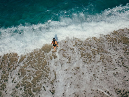 Aerial top view young woman on the sand beach