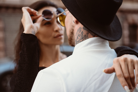 A young, sexy couple of lovers pose for a camera on the streetsの写真素材