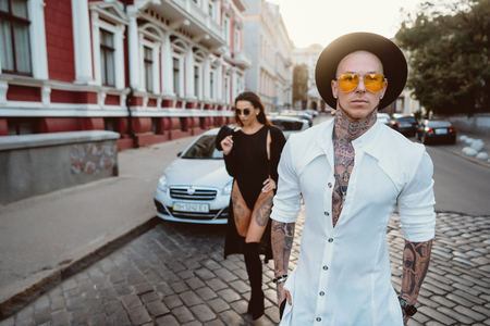 A young, sexy couple of lovers pose for a camera on the streetsの写真素材