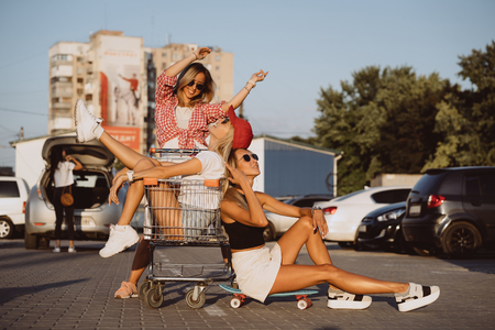 Young women with a supermarket cart have funの写真素材