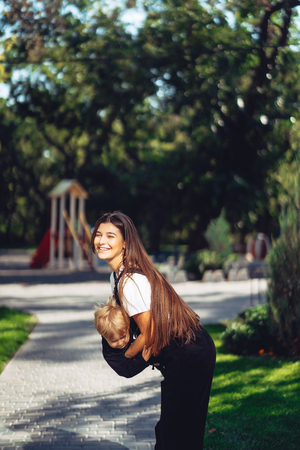 Beautiful young mother holds on hand her little sonの写真素材