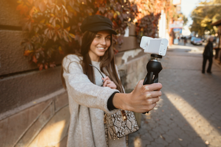 Cute, young female blogger posing on camera.の写真素材