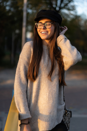 Attractive, young brunette with long hair walking autumn park.の写真素材