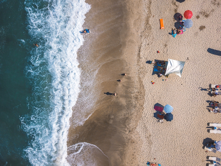 Beach with sun loungers on the coast of the ocean