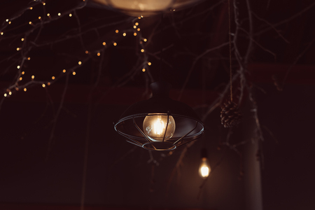 Lamp hanging outside on a dark background.の写真素材