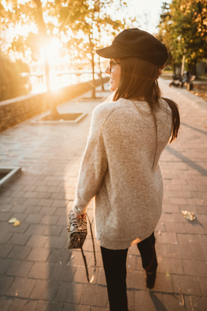 Attractive, young brunette with long hair walking autumn park.の写真素材