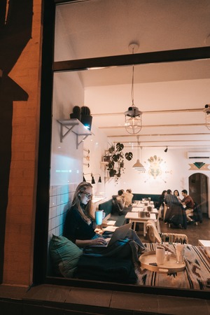 Woman works at a cafe in the eveningの写真素材