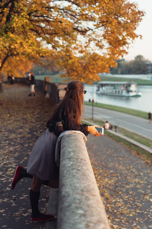 Attractive woman using smartphone outdoors in the parkの写真素材