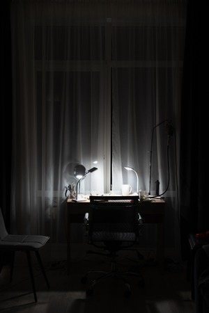 workplace in the room with the lamp on