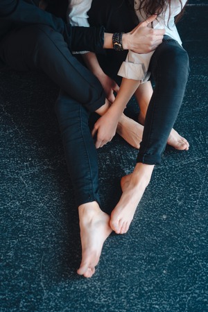 beautiful girls sit by the wall and poseの写真素材