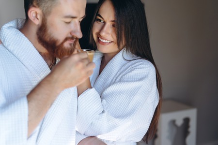 Happy couple enjoy each others company in a hotel room.