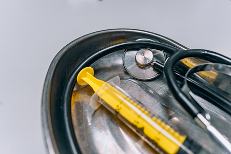 On the surgical tray is a syringe and stethoscope, close viewの写真素材