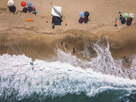Beach with sun loungers on the coast of the oceanの写真素材