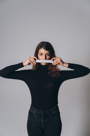 Portrait of a pretty smiling woman posing isolatedの写真素材