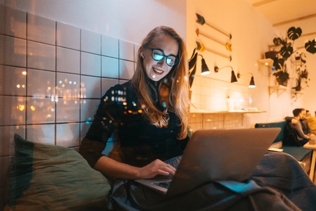 Woman works at a cafe in the eveningの写真素材