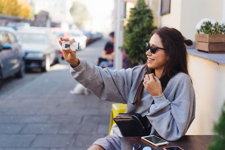 Cute, young female blogger posing on camera.の写真素材