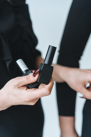 Woman holds black mascara in her handの写真素材