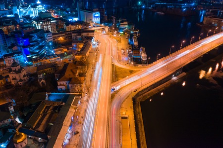 Highway at night in modern city. Aerial view of cityscape