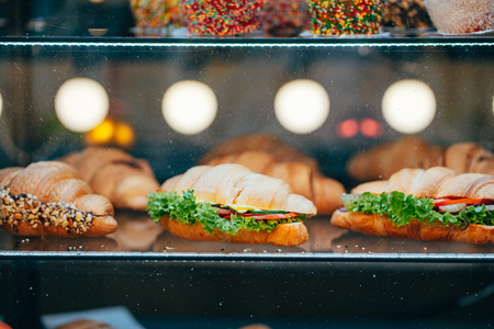 Fresh sandwiches with meat lie on the displayの写真素材