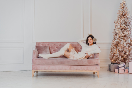 Beautiful woman is lying on the sofa.の写真素材