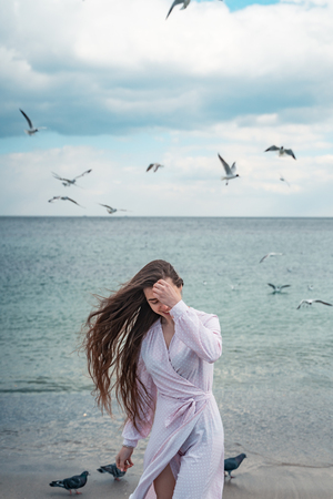 Beautiful unusual woman walking on the beachの写真素材
