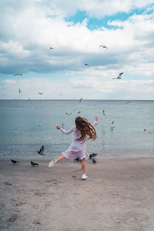 Beautiful unusual woman walking on the beachの写真素材