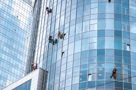 Workers washing windows in the office buildingの写真素材