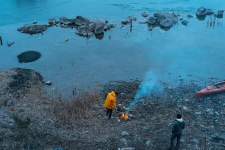 The guy on the lake makes a fire