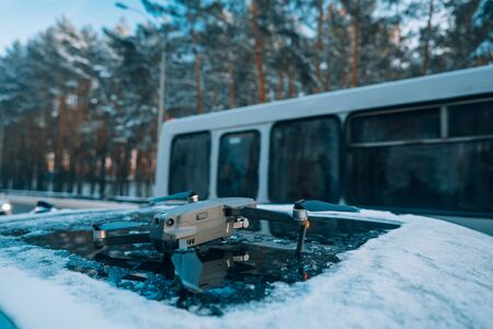 quadrocopter standing on the roof of a snow-covered carの写真素材