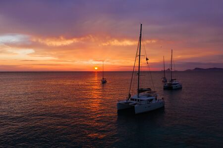 Aerial view from drone on boats shipping in sea, sunset. Yachting with a dramatic sunset as backdropの写真素材