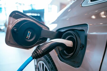 Power supply plugged into an electric car being charged.