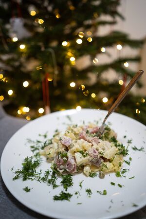 Traditional Russian Christmas Salad Olivier on a white plate.の写真素材