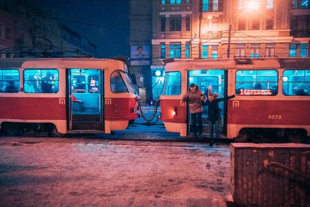 Young adult couple holding each other hands on snow covered street