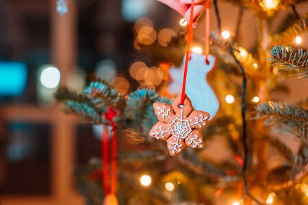 Christmas tree decorated with gingerbread cookies and garland, close-up viewの写真素材