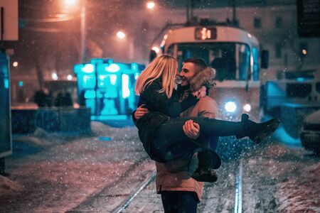 Young adult couple on the snow-covered tram lineの写真素材