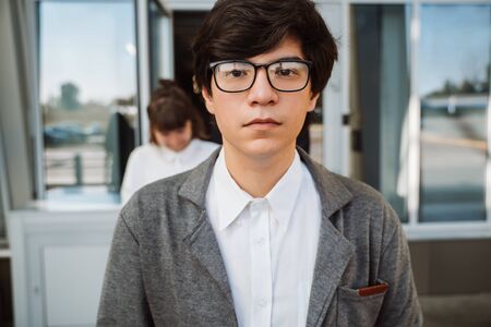 man with glasses stand at streetの写真素材