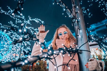 Girl posing against the background of decorated treesの写真素材