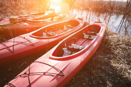 Group of canoes rental kayak on the lake shore beach. Kayak ready to sail