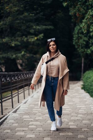 Closeup portrait of beautiful fashionable woman in park.の写真素材