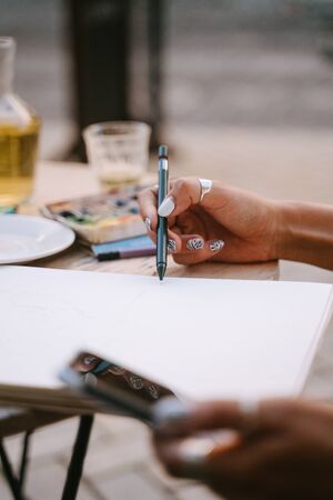 Street portrait artist sketch a picture on the streetの写真素材