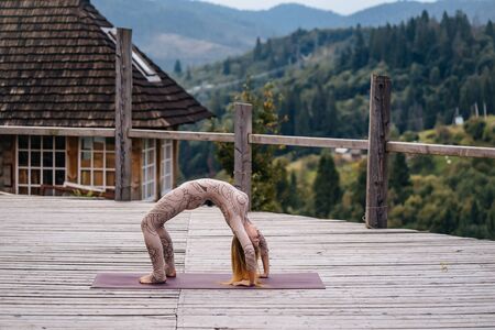 Woman practices yoga in mornin, fresh air.