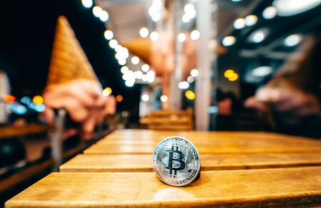 Silver bitcoin isolated on the table, glowing backgroundの写真素材